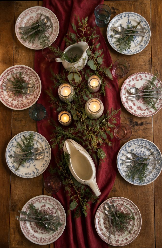 An eclectic arrangement of vintage dishes on a holiday table.
