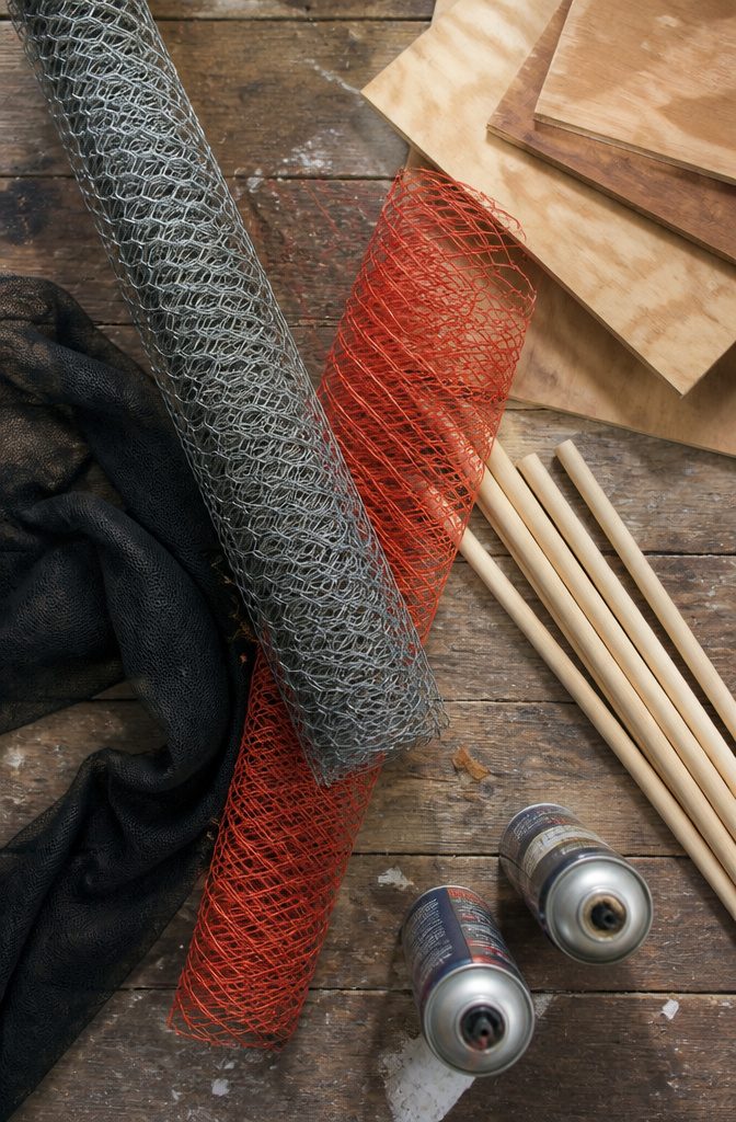 Various materials for DIY spider decorations laid out on a table.